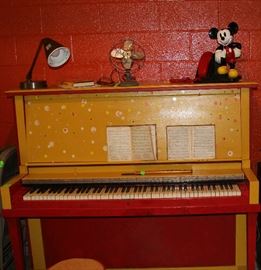 The beautiful and fun yellow piano with polka dots. Look at Mickey on top and a metal fan.