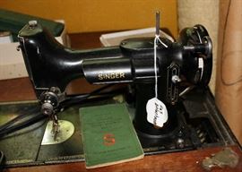 Old Singer sewing machine with accessories and instructions. Very old.