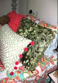 The decorative pillows on the twin bed.