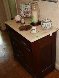 A oak stand with marble top.