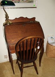 A small oak desk with chair.