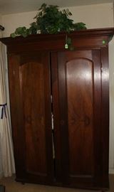 Beautiful antique walnut amoire with hanging rod and shelves.