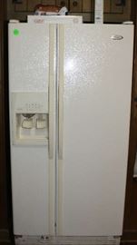 Refrigerator with freezer on side and ice maker.