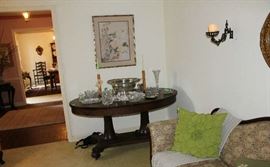 Beautiful mahogany oval table on pedestal with silver punch bowl, silver ladle and crystal pieces.