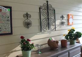 Metal wall hangings under car port.