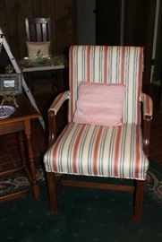 Chair with rose colored and blue stripe.