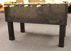 foos ball table from the side .