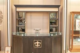 This is a 2 piece bar with granite counters and complete rear hutch/display. It has storage and a pull out shelf with cabinet doors front and back.