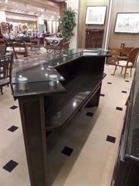 This is a 2 piece bar with granite counters and complete rear hutch/display. It has storage and a pull out shelf with cabinet doors front and back.