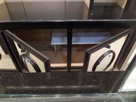 This is a 2 piece bar with granite counters and complete rear hutch/display. It has storage and a pull out shelf with cabinet doors front and back.