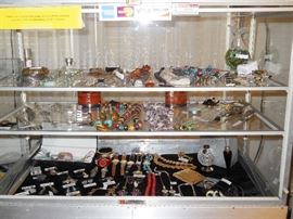 Showcase filled with jewelry, Waterford ornament w/stand & box, Perfume, watches, etc.
