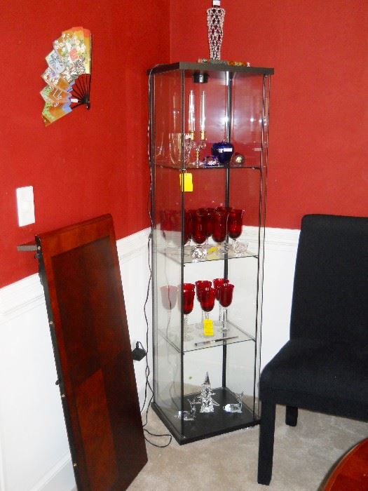 glass curio cabinet, red stemware, Baccarat paperweight, Blenko cobalt apple, etc.
