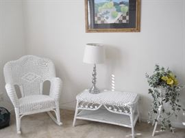 white wicker rocking chair, table and plant stand, etc.