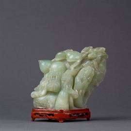 AN ASIAN CELADON OR NEPHRITE JADE CARVED ELDER