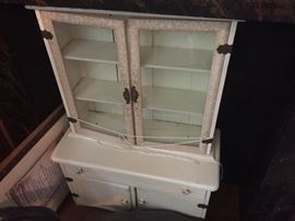 Antique child's size step back cabinet with glass doors in white