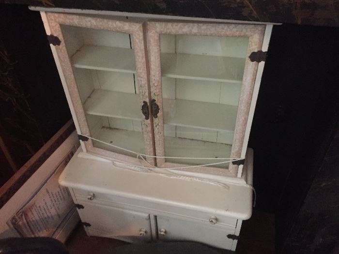 Antique child's size step back cabinet with glass doors in white