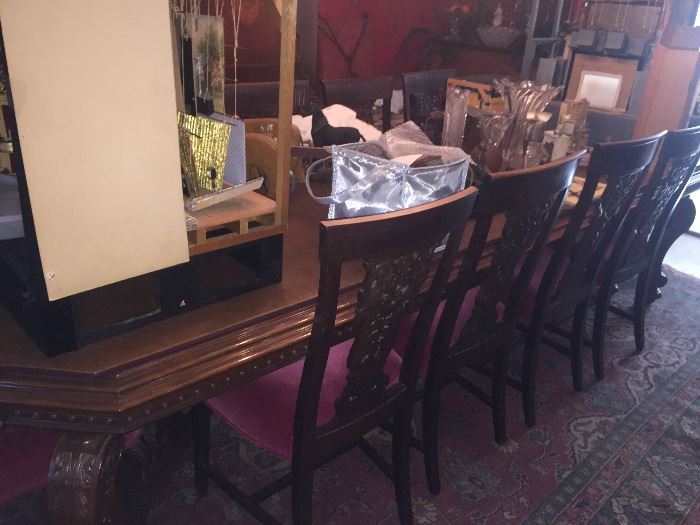 Antique 10 foot walnut dining room table with leaves and 14 chairs, shownwith custom padding that goes with set
