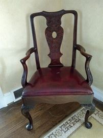 Carved back mahogany open armchair, small tear in leather seat