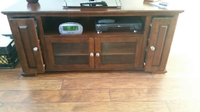 Display your big screen TV on this beautiful console.  This entertainment console features durable solid hard wood construction, storage spaces with doors for hidden storage, and adjustable shelves to keep electronics organized and handy.