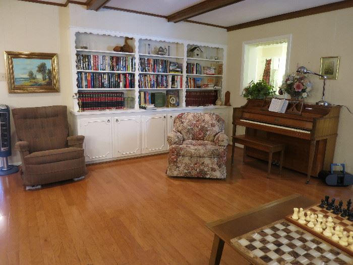 Rocking Recliner, Nice Upholstered Sitting Chair And Anther Look At The Piano And Hardback Book Area