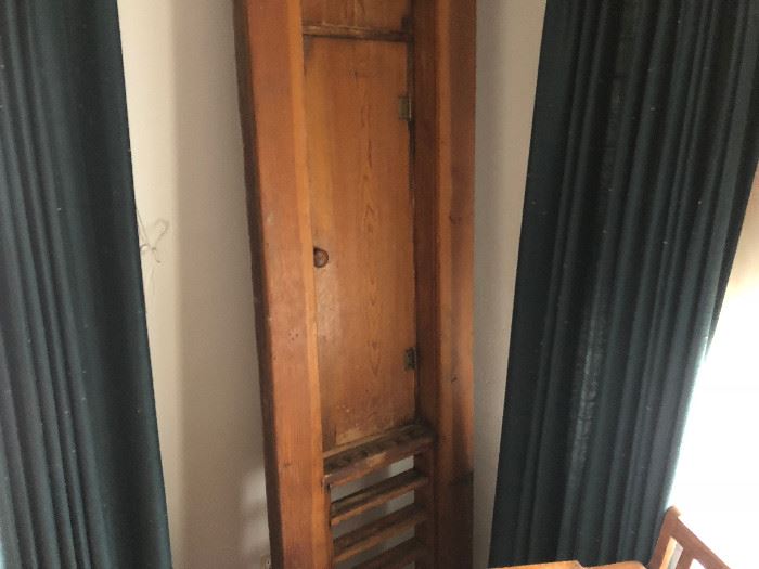 Billiards rack with small door. Appears to be a custom made piece. 