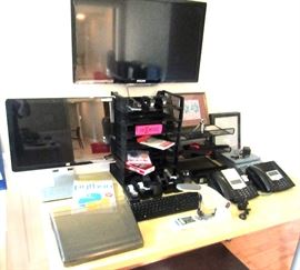 Another wall mounted TV, large Dell monitor, other office items