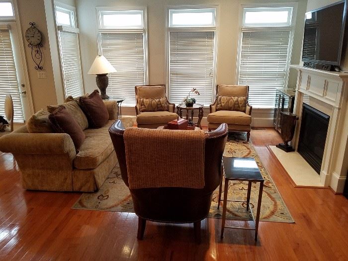 TV entertainment area on 2nd floor with leather stylized wing back, Century arm Chairs/ottomans, roll arm sofa, area rug, end tables, double wine cooler, flat screen tv