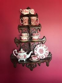 Beautiful antique carved rosewood wall etagere. Also pictured are just a few pieces of red and white transferware from England.