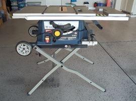 10" Ryobi table saw on table folds down to roll.