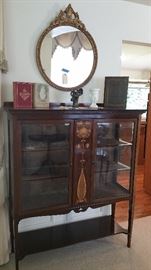 antique English display cabinet with art nouveau marquetry - excellent condition....round vintage mirror,,,vintage books