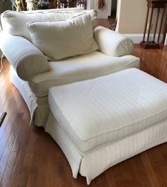 White upholstered overstuffed armchair and ottoman