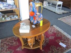 Four elephant stools under oval coffee table