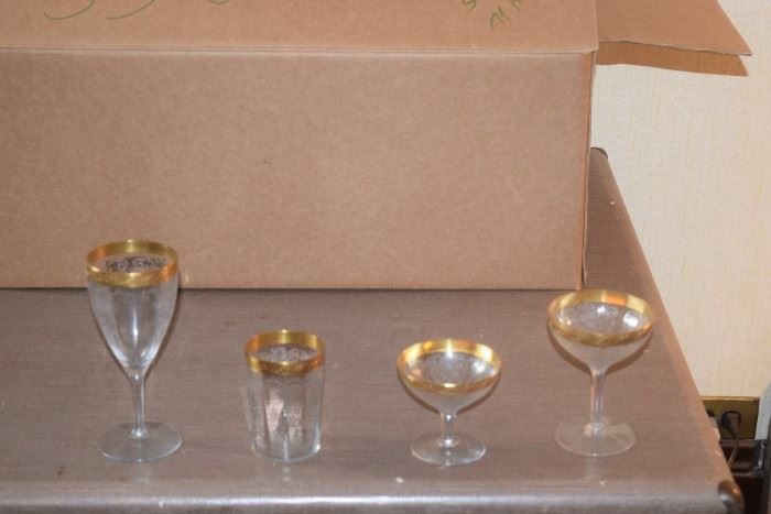 Gold rimed glass setting for 4 or more people.