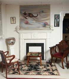 Fine needlework rug, antique iron fireplace surround.