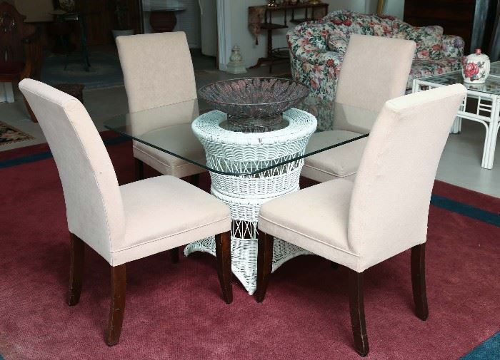 Glass top wicker table with four Parsons chairs.