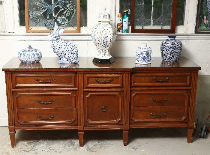 Vintage credenza with decorative blue and white items.