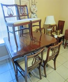 Duncan Phyfe style drop leaf table with two additional leaves and six chairs ...pedestals move to support drop leaves
