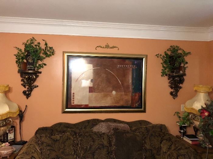 Great wall sconces and artwork behind sofa