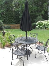 Great wrought iron patio set and like-new umbrella from Hearth & Patio