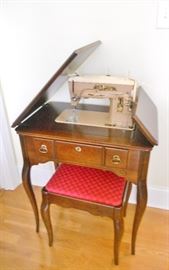 Singer sewing machine in cabinet and stool