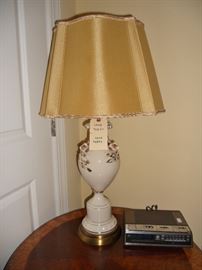 Round inlaid table by Baker Furniture                                                                 Lovely porcelain lamp with 3-D flowers