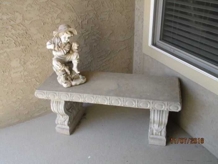 concrete bench and figurine