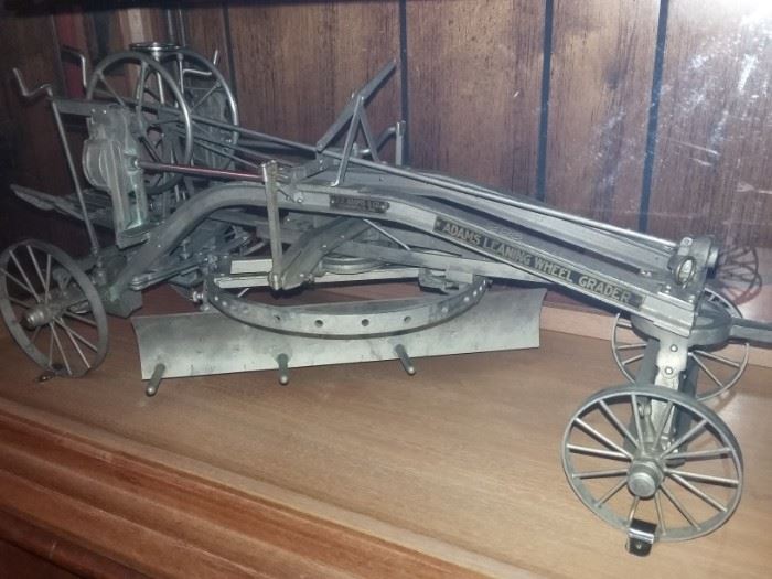Rare Salesman Sample of Adams Leaning Wheel Grader by J.D. Adams & Co. Road Building Machinery  housed in a custom-made wood & glass display case, and includes Adams Mfg. Co original salesman's travel case with tag used for this road grader.