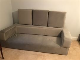 Origami futon. Can be set up as a twin bed as shown previously. Laid out as a king bed. Or made into a couch as shown here.