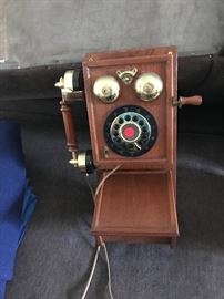 Button dial wall phone made to look like old fashion roatary phone with storage on bottom.