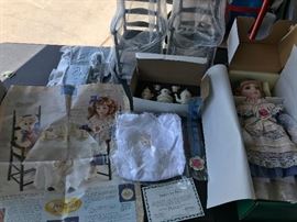 There are a large number of dolls from various designers including several sets all with original certificates and numbered. This is Lenox’s Emily’s Tea Party with table, linens, doll, and two chairs.