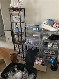Wine rack with glass holder and liquor shelf. Various household items. Bucket of high end creams, soaps and lotions with instructions.