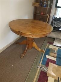 Antique round solid wood table with claw feet