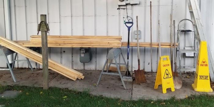 Cones, lumber, yard tools, saw horses