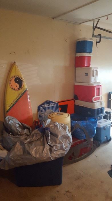 Surfboard, coolers, tent, signs